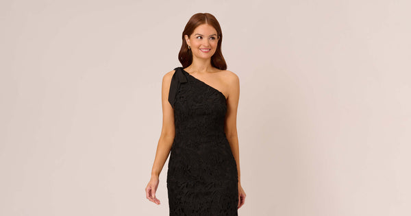 One Shoulder Lace Sheath Dress With Bow Accent In Black Adrianna