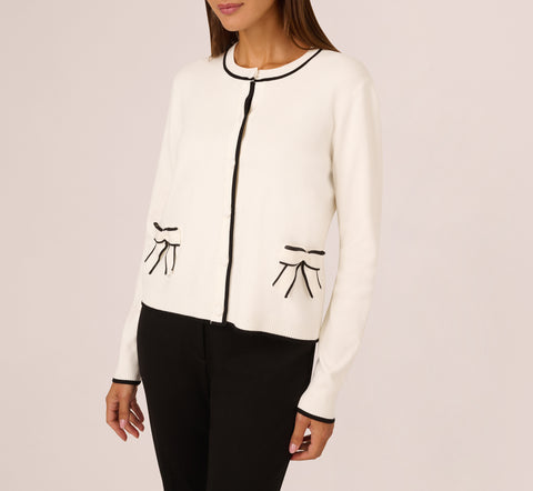 Crew Neck Tipped Bow Pocket Cardigan Sweater In Ivory Black