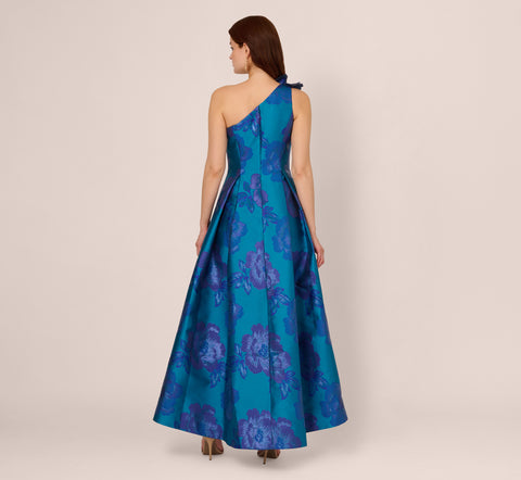 Floral Jacquard One Shoulder High Low Gown With Rosette Accent In Teal Blue