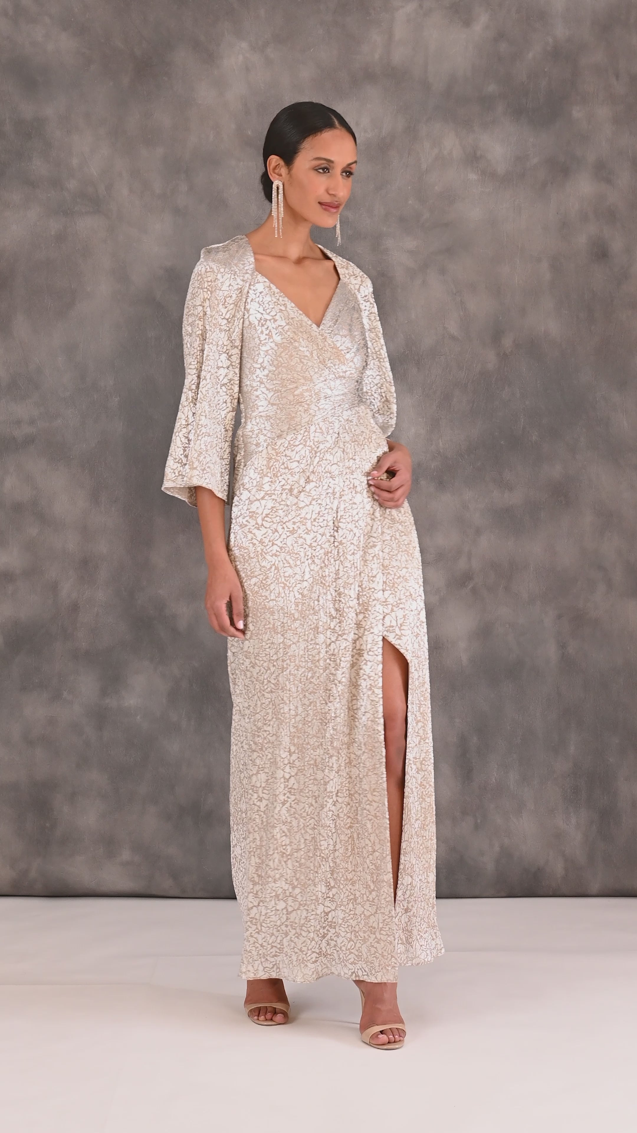 Pleated Foiled Long Column Dress With Slit And Flutter Sleeves In Silver Gold